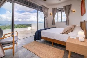 a bedroom with a bed and a view of the ocean at Villa Mustique - Perfect tropical paradise in El Limón +102 photos