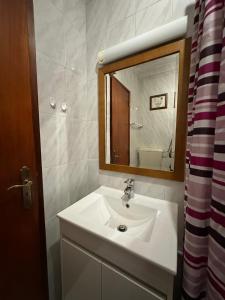 a bathroom with a white sink and a mirror at Alvor Riverview in Alvor +27 photos