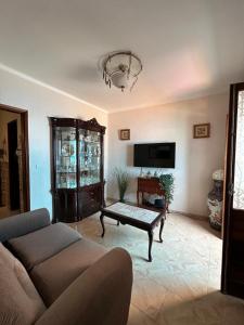a living room with a couch and a tv at Alvor Riverview in Alvor