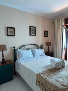 a bedroom with a bed and two lamps and a window at Alvor Riverview in Alvor