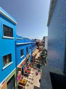 an overhead view of a blue building with people on the street at Alvor Riverview in Alvor