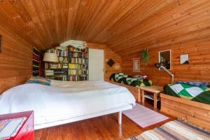 a bedroom with a bed in a wooden room at Scandinavian summer cottage in Asikkala in Asikkala