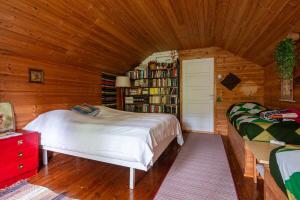 a bedroom with a bed and a book shelf at Scandinavian summer cottage in Asikkala in Asikkala