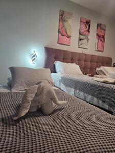 A bed or beds in a room at Theo and MS Luxurious Apartments