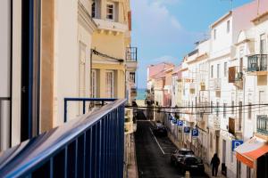 a view from a balcony of a street with buildings at Seabreeze Nest by Feel Nazaré in Nazaré