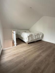 a bedroom with a bed and a wooden floor at Residence du bois 2 in Mitry-Mory
