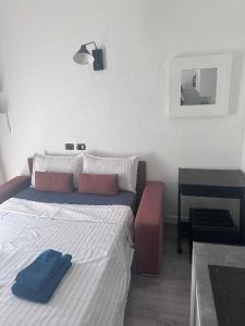 a bedroom with a bed with a blue towel on it at joli studio en face de la gare in Nice