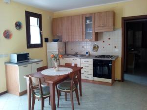 a kitchen with a table and chairs and a kitchen with a stove at Mon Refuge Villa Deluxe in Correzzola