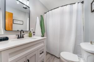 a white bathroom with a sink and a toilet at Cozy Corner in Terre Haute +23 photos