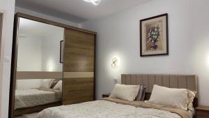a bedroom with two beds and a large mirror at ZENHOME luxury appartement in Dilida +46 photos