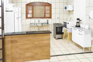 a kitchen with a sink and a counter top at casa do fred enseada in Guarujá
