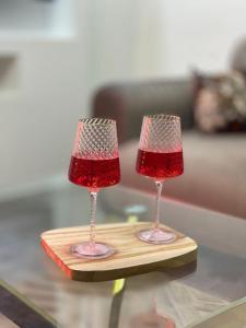 two wine glasses sitting on top of a table at ZENHOME luxury appartement in Dilida