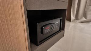 a microwave oven in a door of a room at Palmcasa in Maafushi