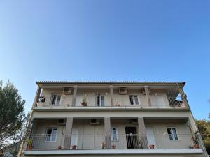 an apartment building with balconies and a blue sky at Sotiria in Paramonas