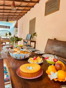 a wooden table with food on top of it at Pousada Caraíva dos Sonhos Oficial in Caraíva +26 photos