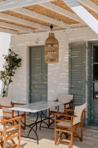 a patio with a table and chairs and a light fixture at VERANNA Patmos D4 in Patmos