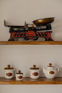 a shelf with four cups and a train on it at VERANNA Patmos D4 in Patmos
