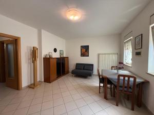 a living room with a table and a chair at Etica Apartment in Gorizia