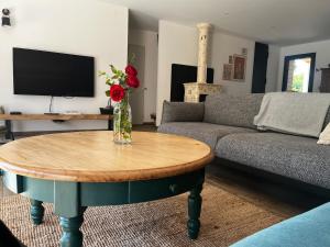 a living room with a couch and a coffee table at Maison Osithe in Doudeauville