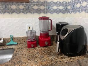a kitchen counter with a blender and a toaster at Brisa Do mar Apartamento 2 in Cabo Frio