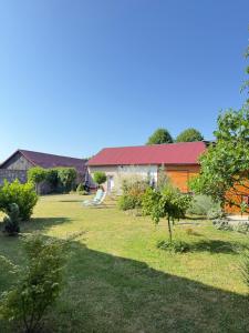a yard with a house with a red roof at Apartment Gabriela in Rakovica