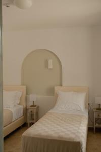 a bedroom with two beds and two night stands at VERANNA Patmos D4 in Patmos +7 photos