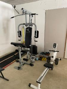 a room with a gym with a chair and weights at Charmante maison basque entre ville et campagne in Arcangues
