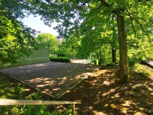 a park with a bench next to a parking lot at Studio Les Epicéas in Boersch