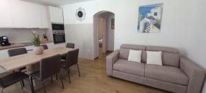 a living room with a table and a couch at VILLA BIANCA - Holiday home with Private pool in Privlaka