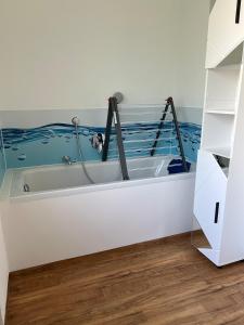 a bath tub in a room with a painting on the wall at Charmantes Feriennest vor Seßlachs Stadtmauer im lebendigen Familienhaus in Seßlach