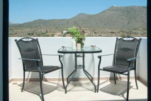 a table and two chairs on a balcony with a view at Anastasia Studios in Avlemonas