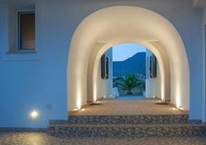 an archway leading to a villa at night at Anastasia Studios in Avlemonas