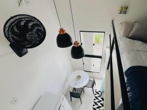 a bedroom with a bed and a table and a mirror at Loft Aconchegante & bem localizado VI in Feira de Santana +11 photos
