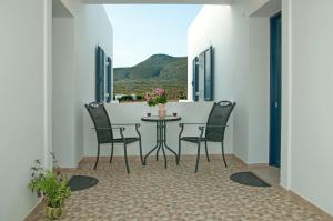 a room with a table and chairs on a balcony at Anastasia Studios in Avlemonas