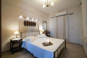 a bedroom with a bed with candles on it at Anastasia Studios in Avlemonas