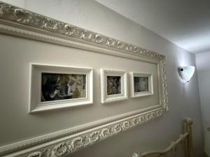 three framed pictures on a wall in a room at Marrone apartment in Valletta