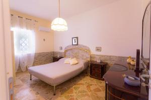 a bedroom with a bed and a desk and a mirror at villa ulivo rovetto in Mandra Capreria +19 photos