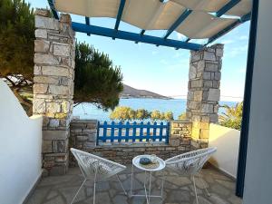 a patio with a table and chairs and the ocean at Fabrika Apartments in Vári