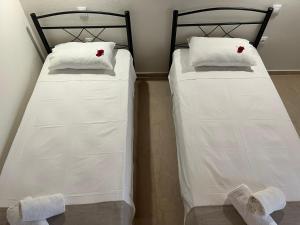 two beds sitting next to each other in a room at Sotiria in Paramonas