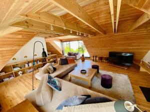 カランテックにあるVilla le 25 - Piscine et Sauna au bourg de Carantecのソファとテレビのあるリビングルーム