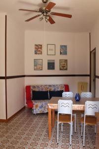 a living room with a table and chairs and a couch at Ida's house in Formia