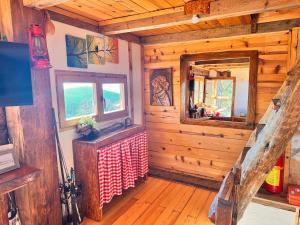 a room with a table and a window in a cabin at Koliba Dobro drvo Off-Grid Cabin Zlatibor in Zlatibor