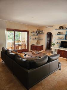 Una sala de estar con un sofá de cuero y una mesa. en Ca n'Estrella, en Santa Gertrudis