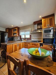 Una cocina con una mesa de madera con un bol de fruta encima. en Ca n'Estrella, en Santa Gertrudis 31 fotos más