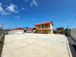 an empty parking lot in front of a building at Relax by the Sea Rooms next to Nibiru in Costinesti