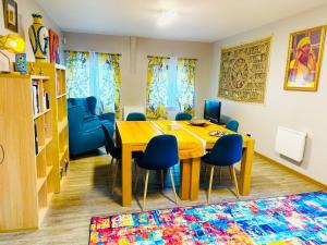 SolgneSolgne的一间带桌子和蓝色椅子的用餐室