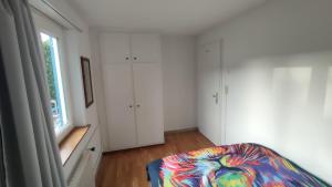 a living room with a couch and a window at Small Double Room, bed 140x200cm, in very quiet and cosy house! in Dübendorf
