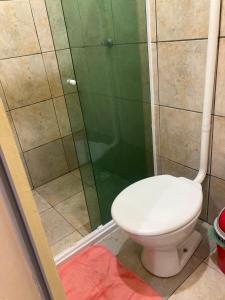 a bathroom with a toilet and a shower at Brisa Do mar Apartamento 2 in Cabo Frio +10 photos