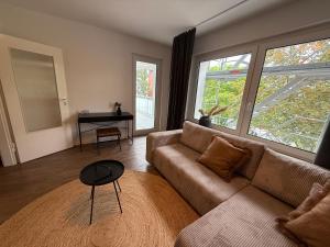 a living room with a couch and a table at Bluemango Signature Apartment No 6 - direkt neben der Messe Essen in Essen
