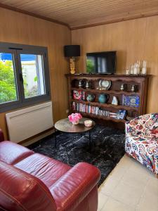 a living room with a couch and a table at Le bureau in Digoin